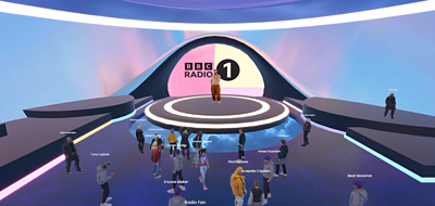 A virtual concert taking place on a Radio 1 stage with avatars of the audience inside the venue and the artist on stage.